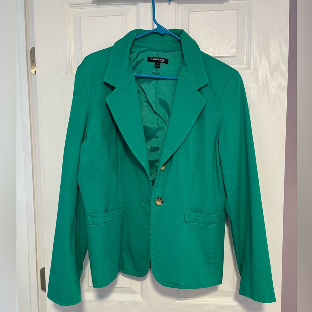 Green blazer with brown button detail on sleeves